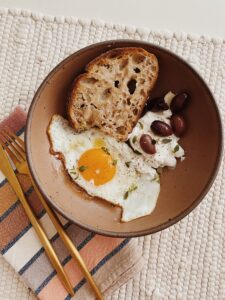 crispy olive oil fried egg with yogurt and olives